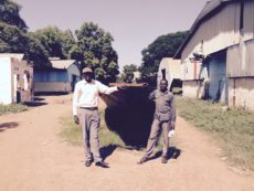 Michael Mayen stands with the boat being built in Juba.